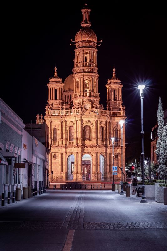 old church structure at the end of the street during night time- 25 Best Places to Visit in Mexico