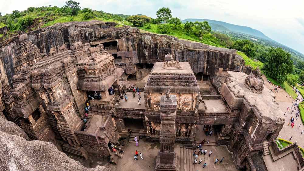 top view of a rock structure with people walking in it - Underground Attractions