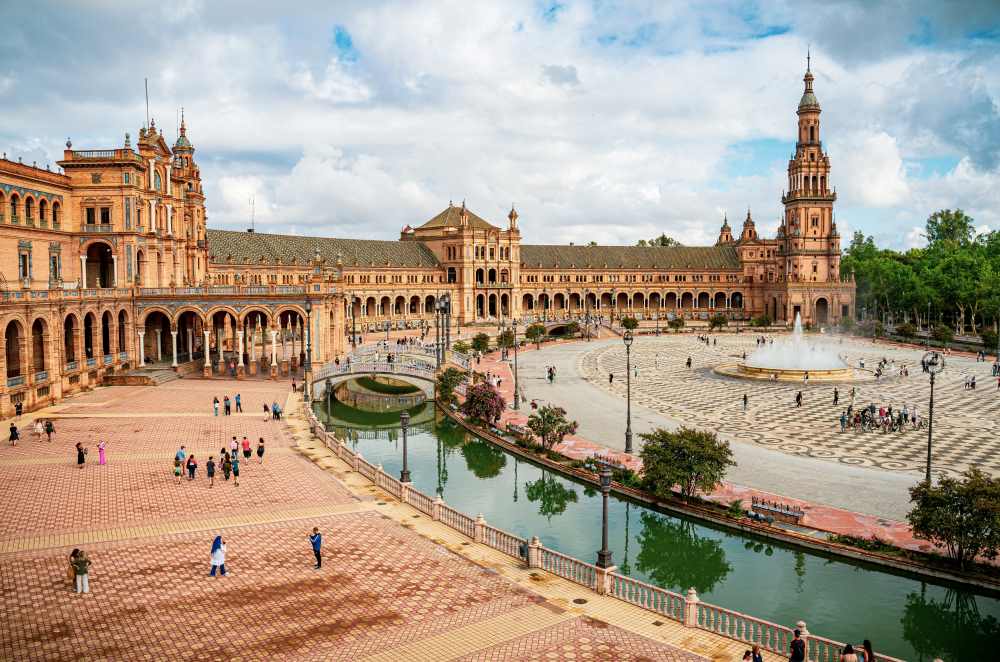 aerial view of an old structure building with water in the middle - Oldest Cities in Europe to Visit in 2025