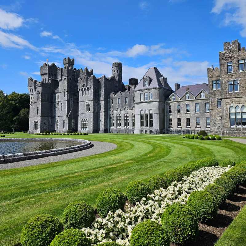 castle like building with garden in front - unique hotels in the world