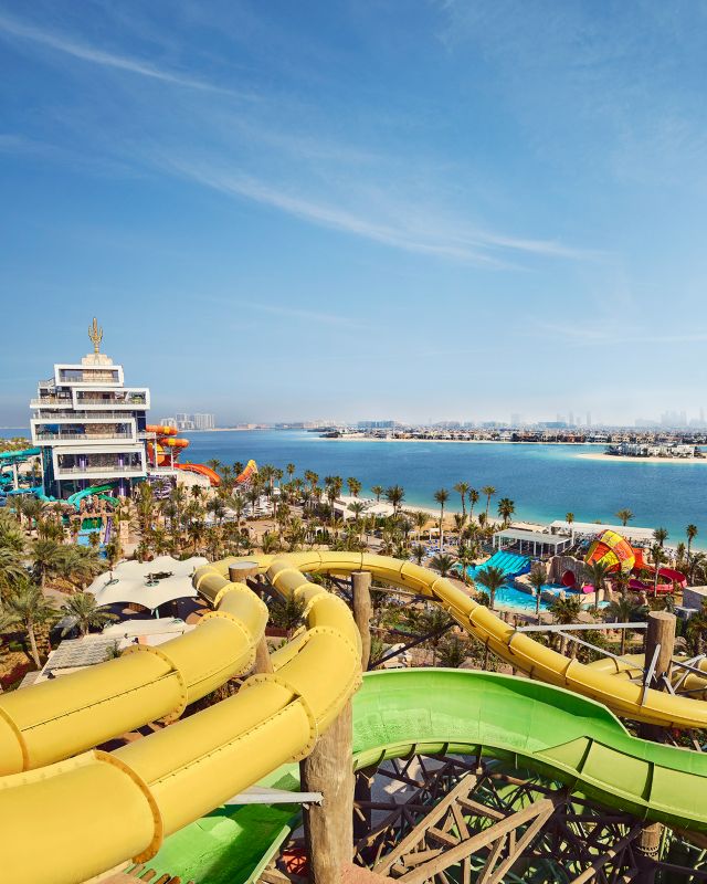 yellow large slide with pools and near the beach