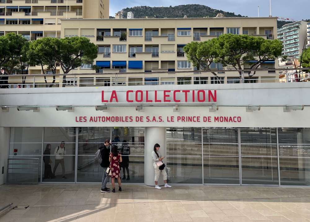 front building of the Automobile Museum of Monaco with people standing in front - Things to do in Monaco 