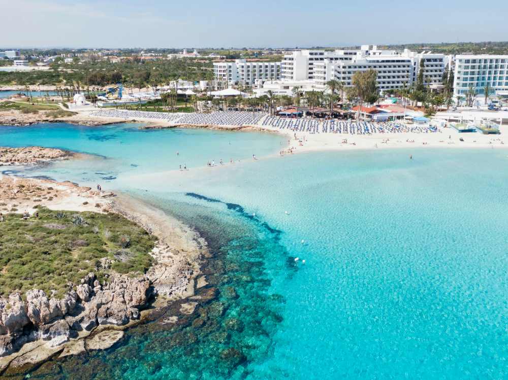 aerial view of the city showing high building and resorts near stunning ocean- cyprus digital nomad visa