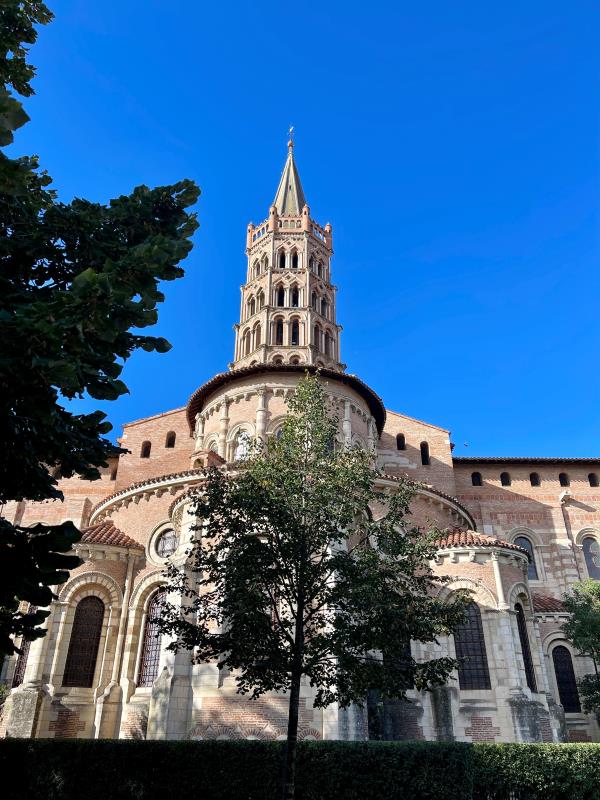 old architectural building with a tree in front