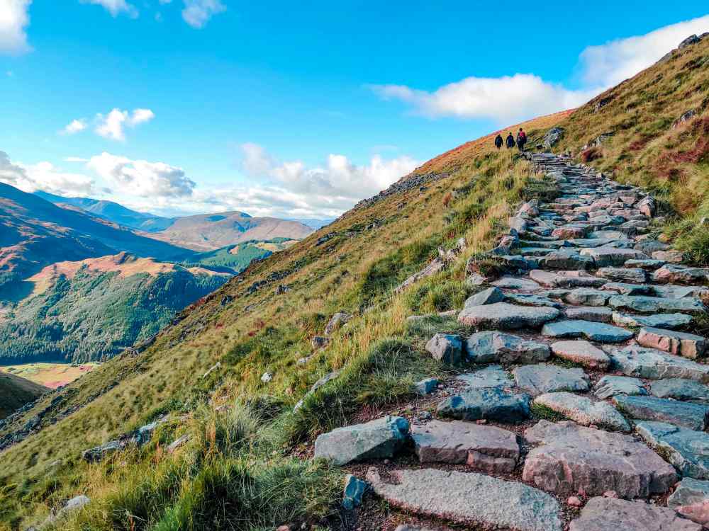 people hiking in the mountain- Things to Do in Scotland