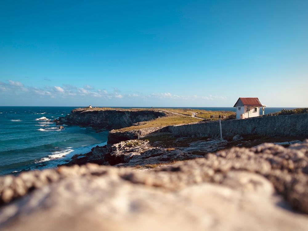 small house at the top of the hill near the beach