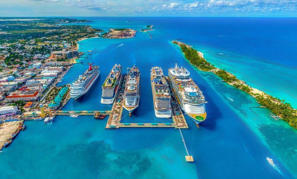 Aerial shot for cruise ship in a beautiful blue sea with houses and building on the side