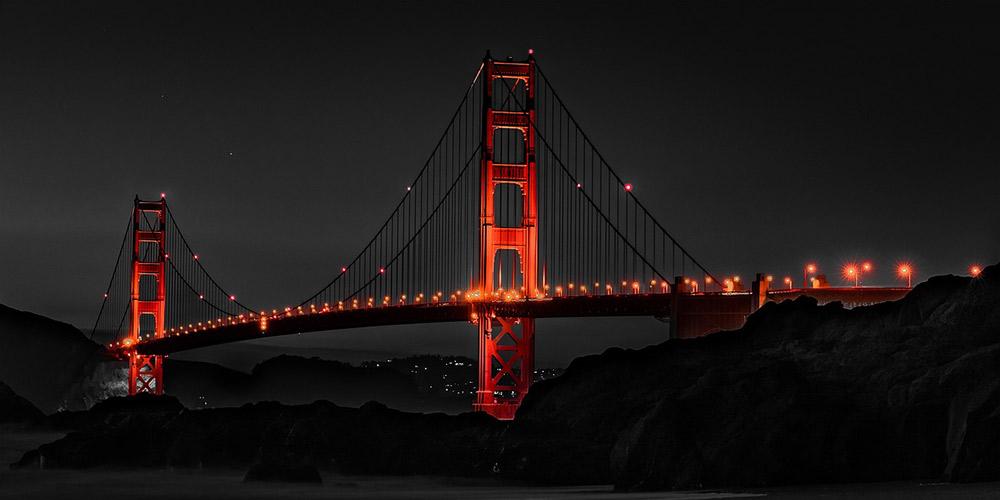 a stunning image of the lighted san fancisco golden gate bridge during nighttime