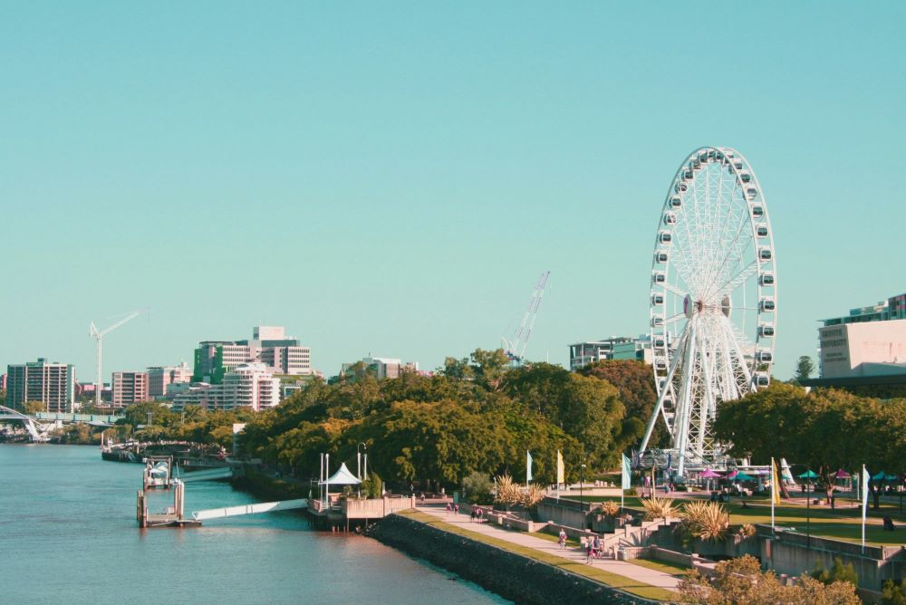 city view showing a giant ferris wheel in the middle of the park near body of water - Best Places to Visit in Australia