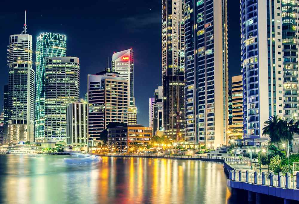 tall buildings in front of the body of water
