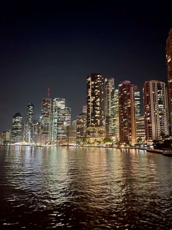 high rise building near body of water during night time