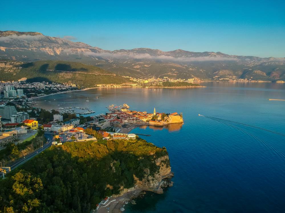 aerial view of a town near body of water and with mountain in the back- montenegro digital nomad visa