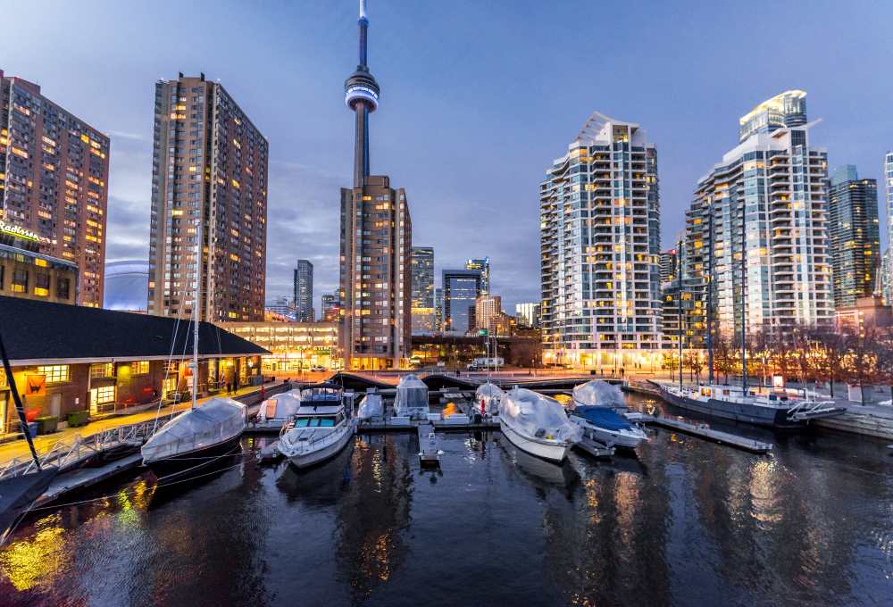 yatch at the sea docks with high rise building in the back ground