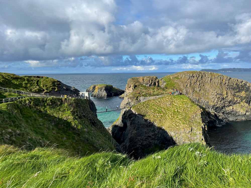 rocky cliff with hanging bridge in between