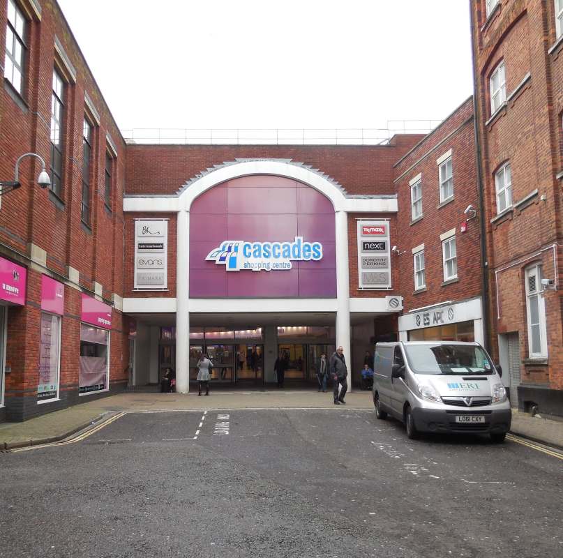 people walking in the entrance of the cascades shopping centre