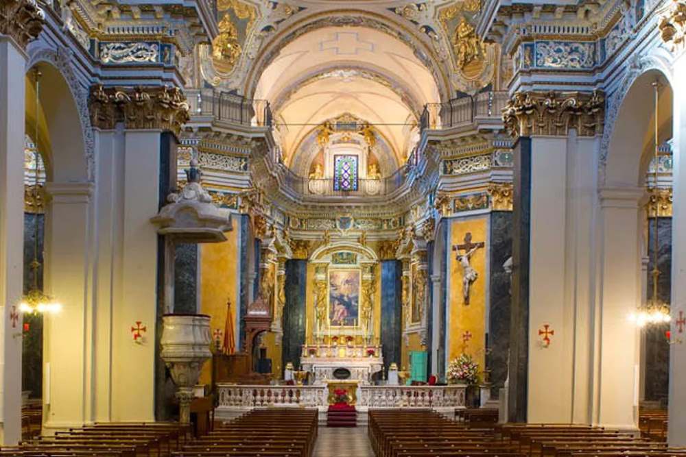 inside the church showing beautiful stained glass and religious artwork- Things to do in Nice, France