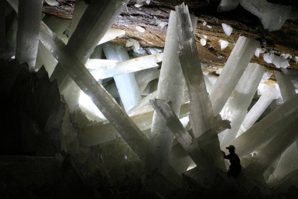 man touching giant crystal