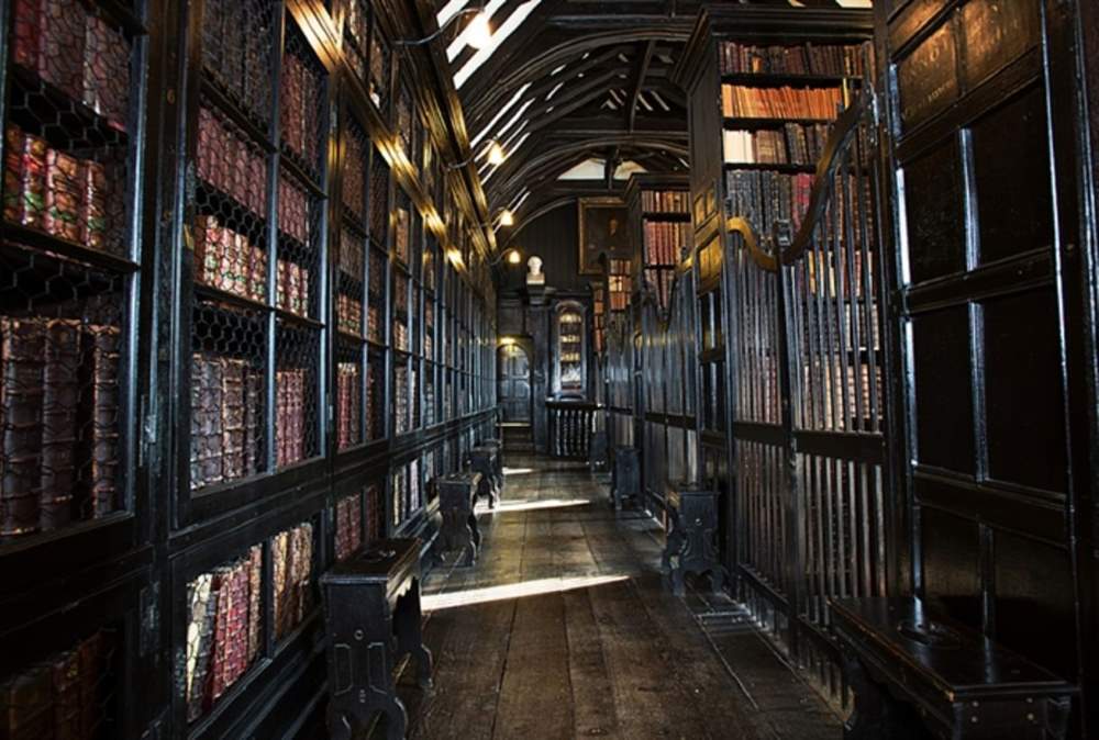 inside of a old library full of books - 30 Unique Things to Do in Manchester UK