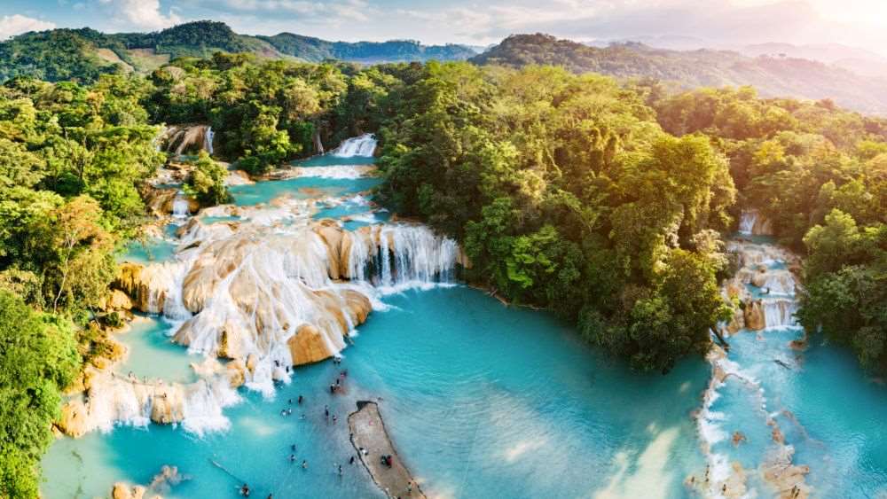aerial view of a waterfalls in middle of forest full or green trees-25 Best Places to Visit in Mexico