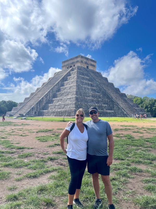 my husband and I taking photo with Chichén Itzá at the background