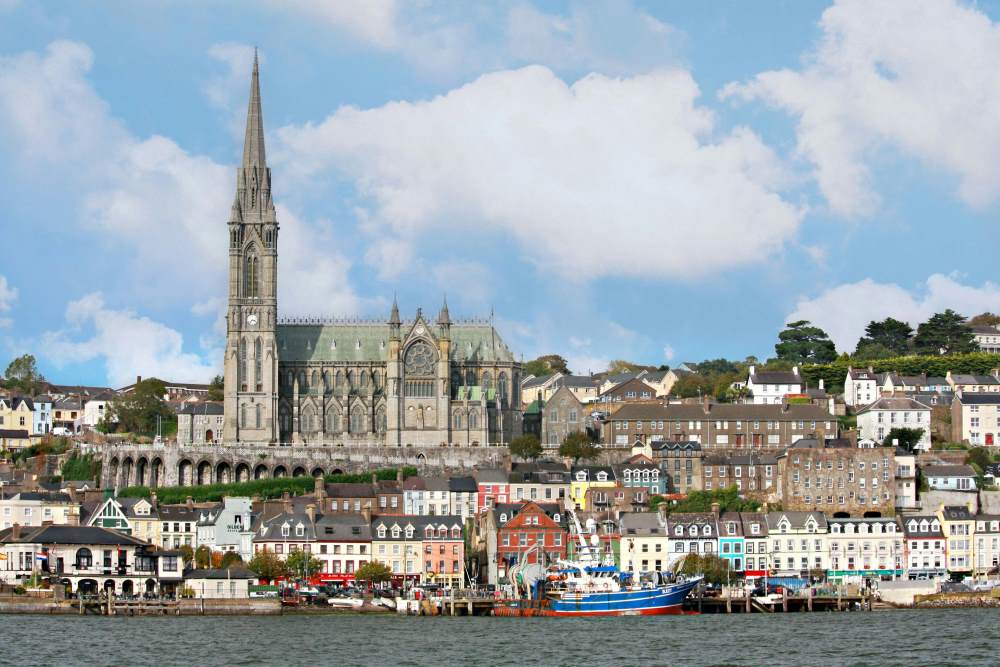 building, houses and boat near body of water