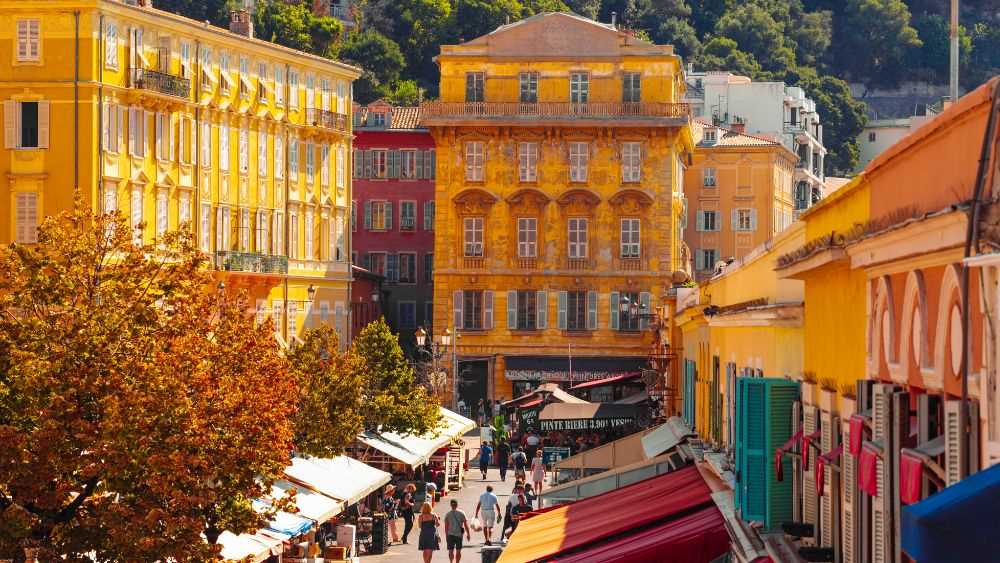 aerial view of people walking around the street surrounded by colorful buildings