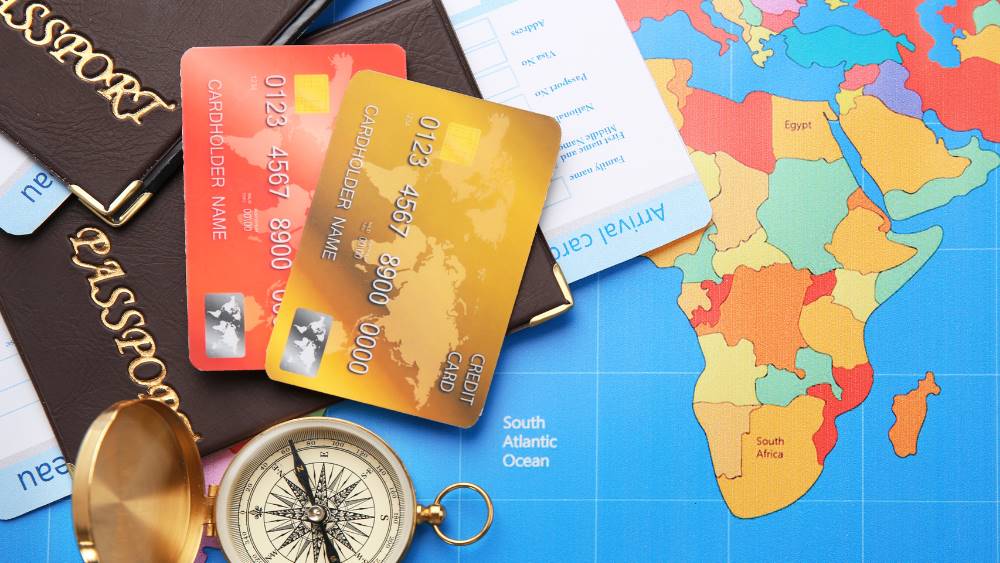 credit cards on top of passport and map of the world