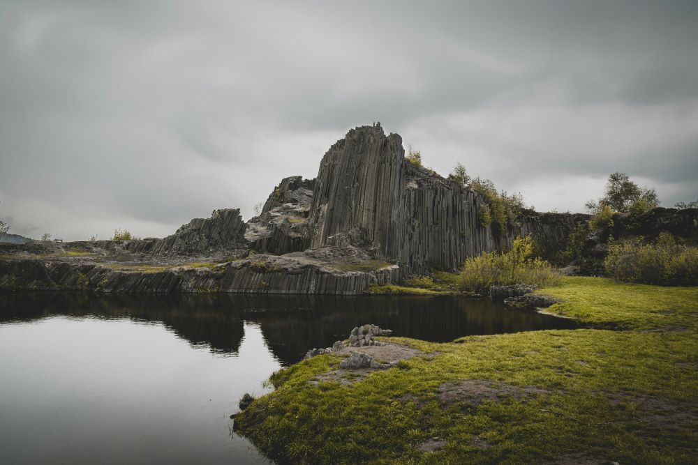 white rock mountain near body of water