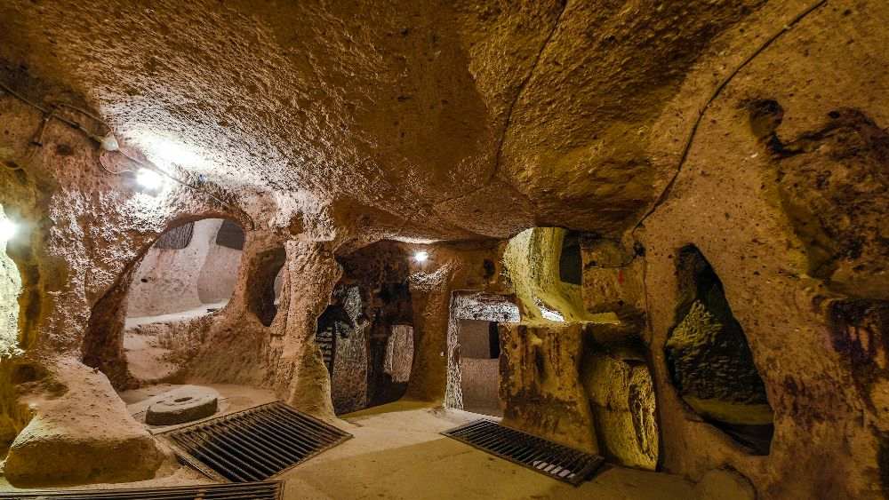 inside a stone like cave with small hole as door - Underground Attractions