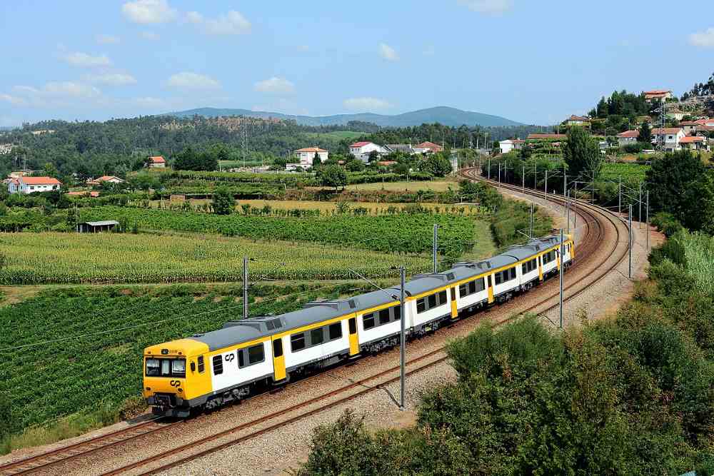 yellow-white train in the middle of valley
