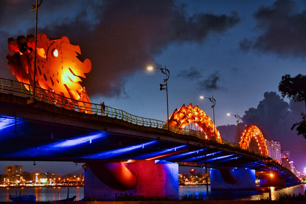 bridge with lit up dragon in it - best cities for nomads