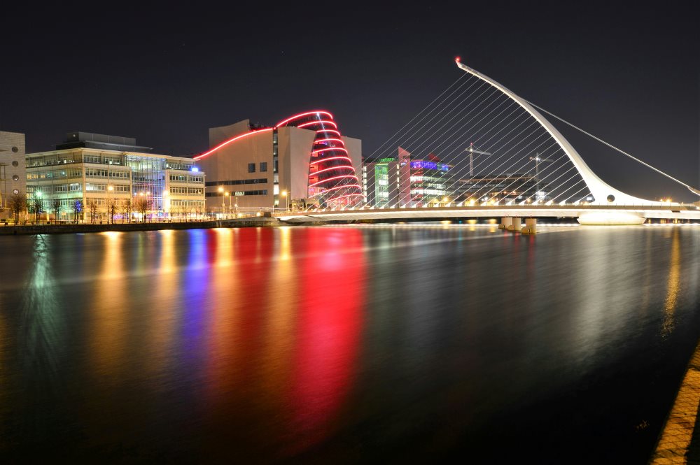 colorful lights in the building reflecting the body of water