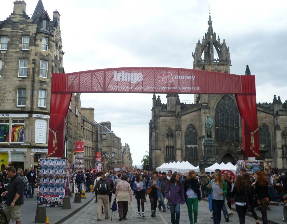 people walking in the street with for the fringe festival
