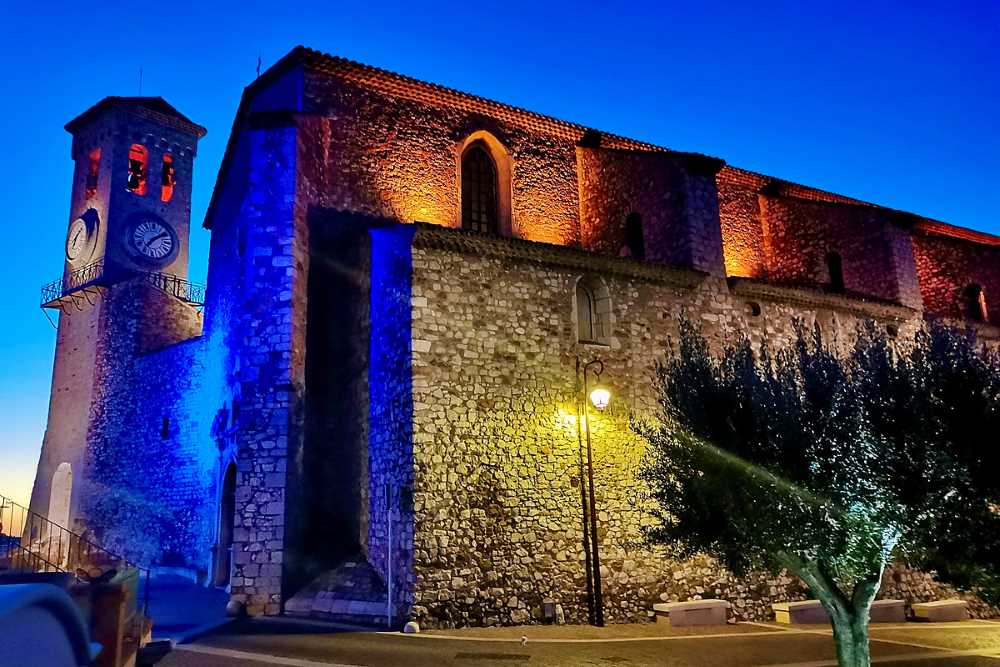 rock brick design church with clock tower during night time -Best Things to Do in Cannes