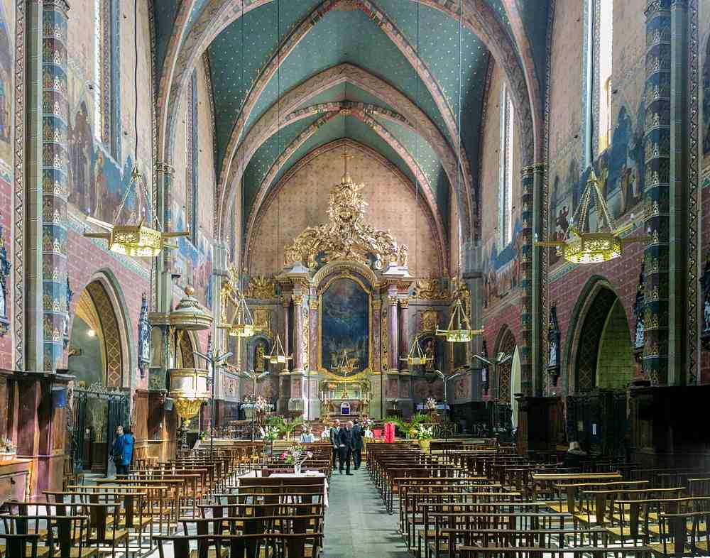 inside view of an old cathedral with people in it