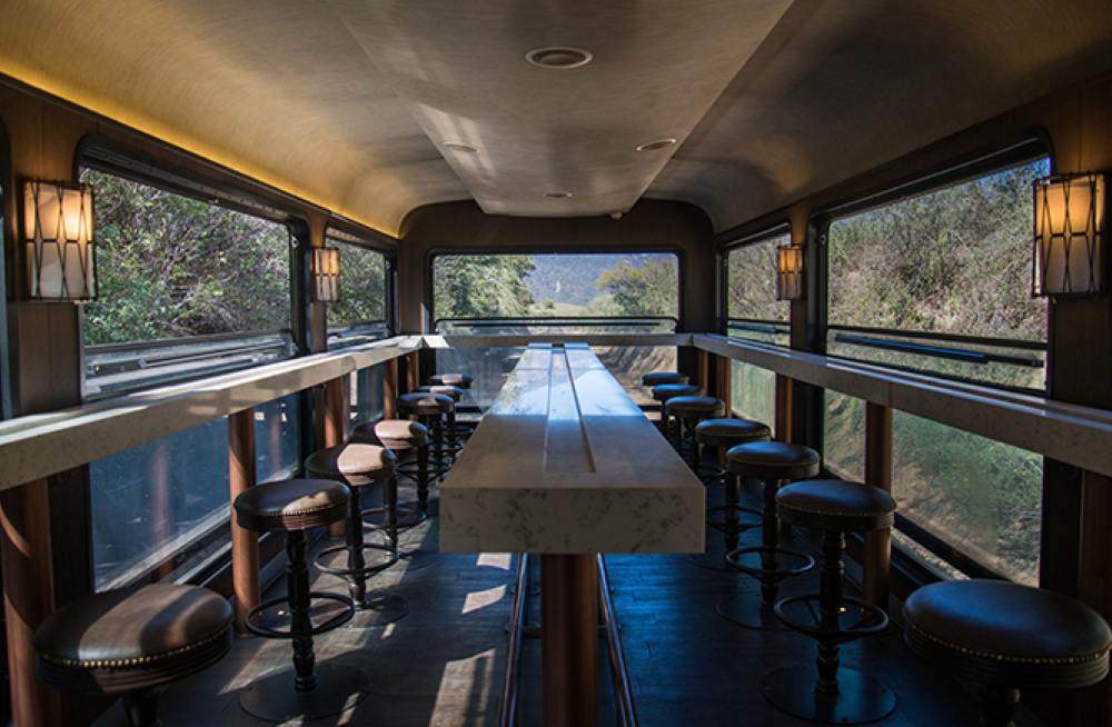 bar stool and table inside a train with glass window