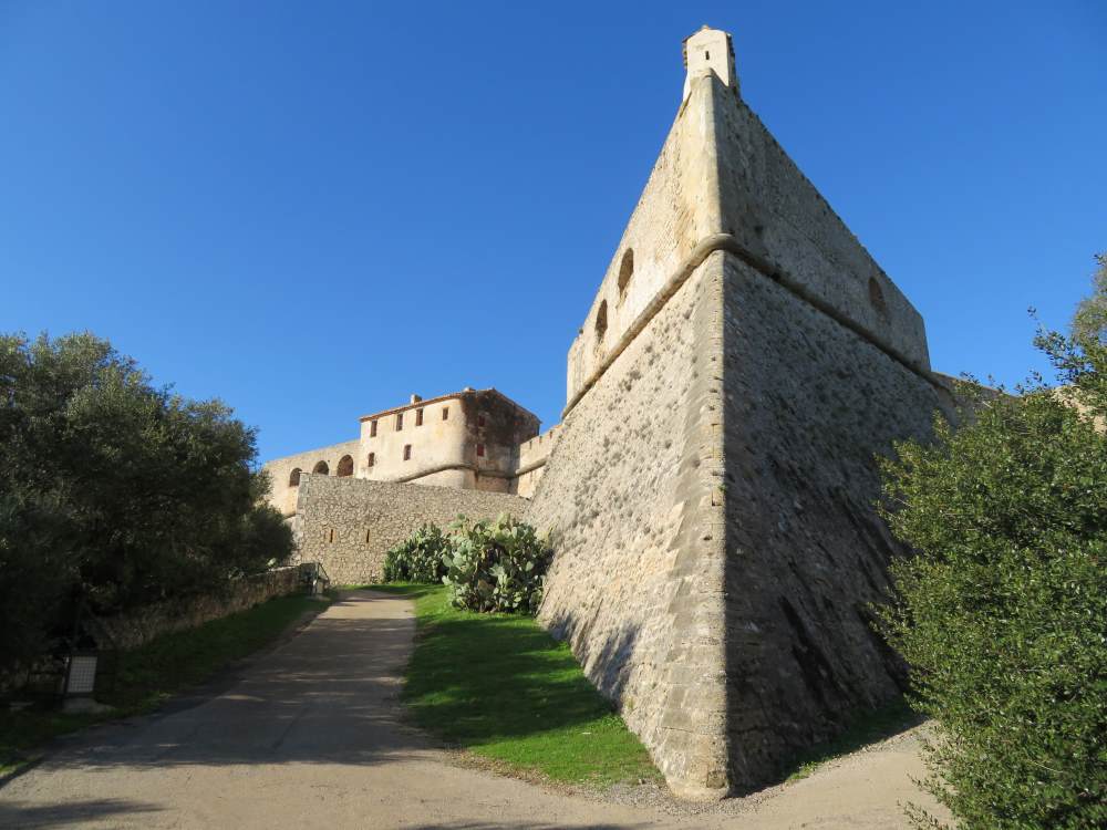 rock made building surrounded by green trees