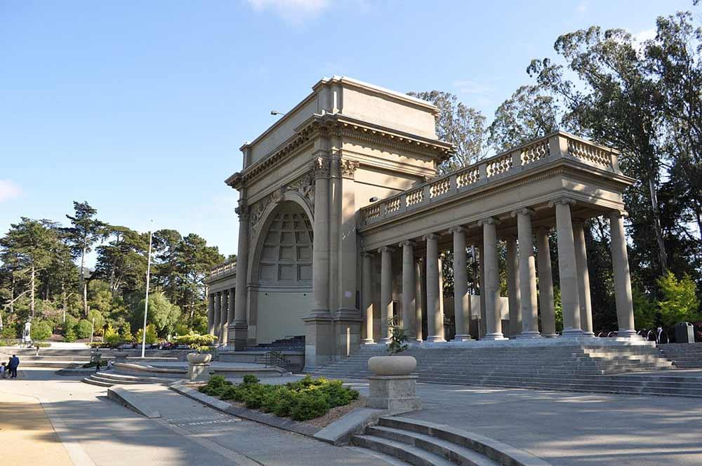 a slightly angled view of the golden gate park spreckels temple of music casting a shadow on the park grounds