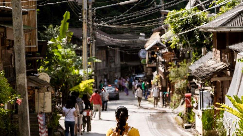 people walking in an alleyway