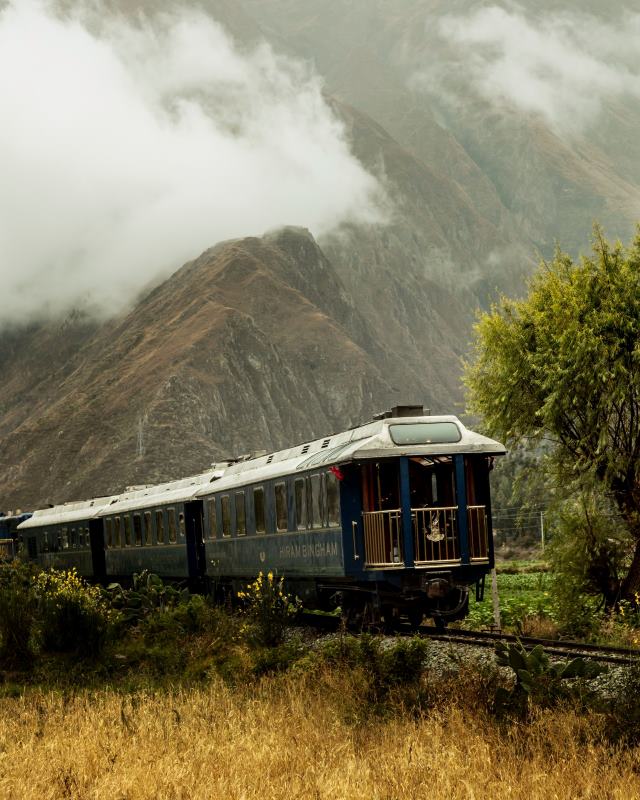 blue train with mountain at the back