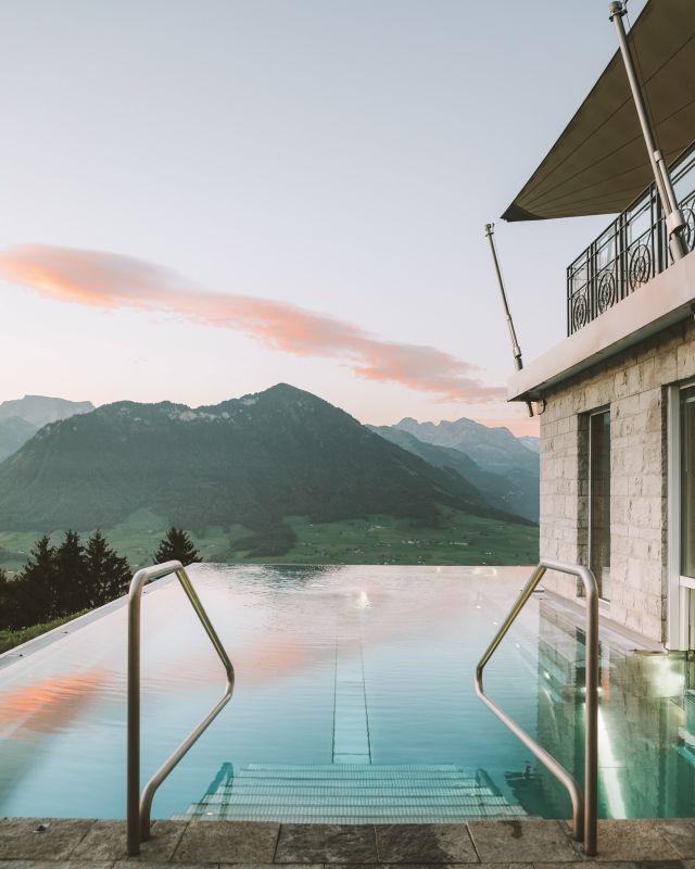 outdoor infinity pool with views of the surrounding mountains.