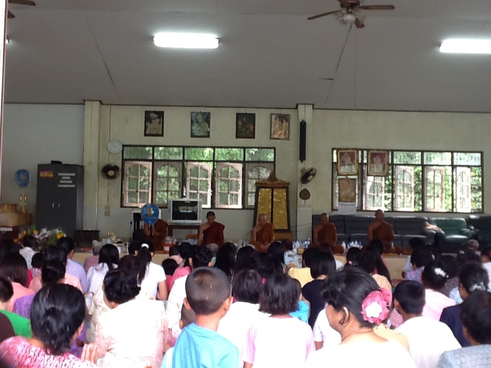 monks inside the room sitting with people in front