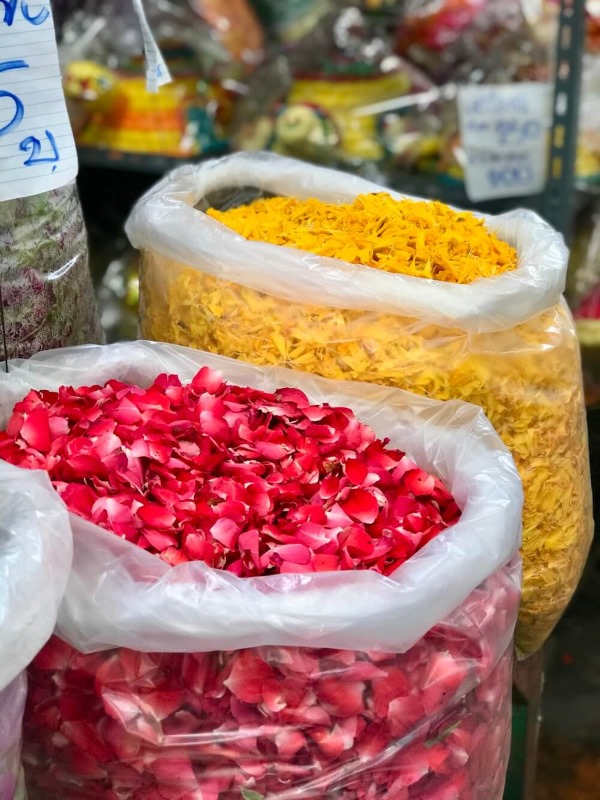 red and yellow petals inside a plastic bags at flower market