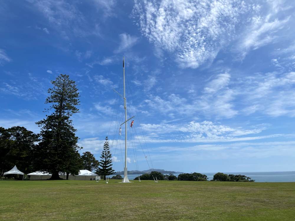 white flag stand in the middle of the hill