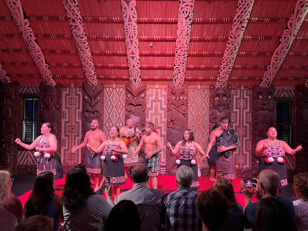 men and women in stage singing with national costumes
