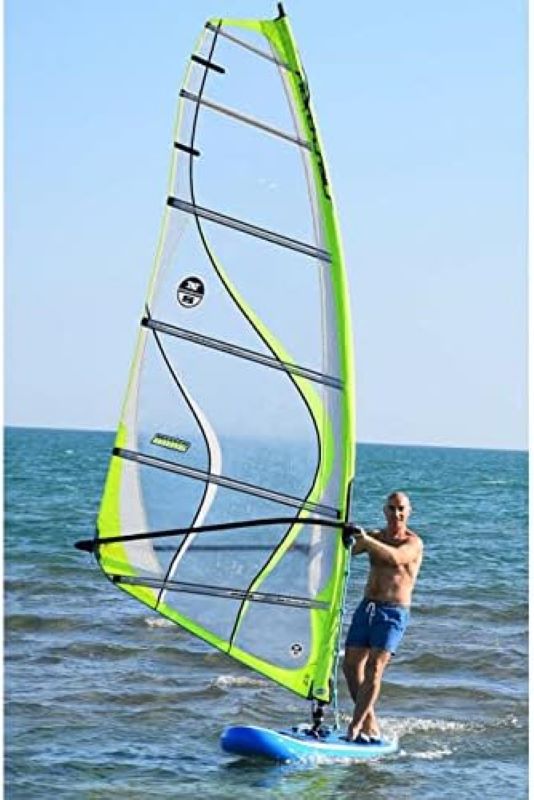 green inflatable windsufer with a man in it