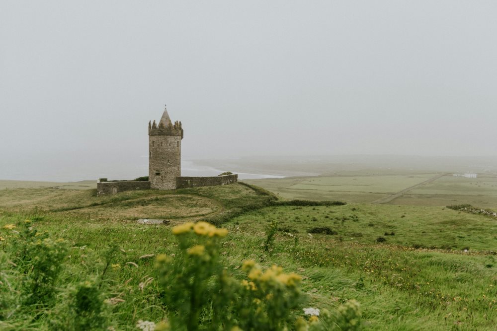 castle in the middle of a green grass hill-ireland digital nomad visa