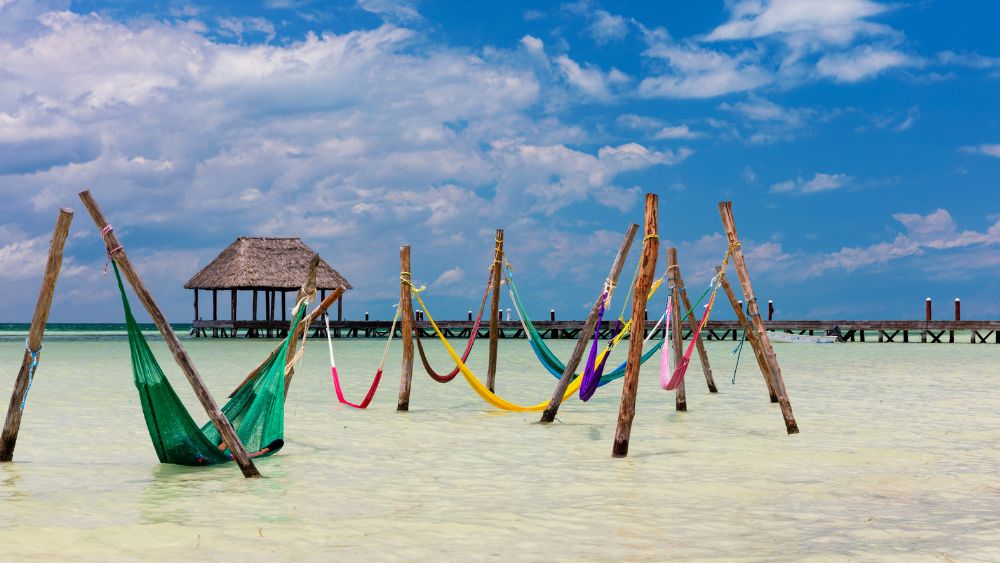 hammocks strung over the shallow turquoise waters