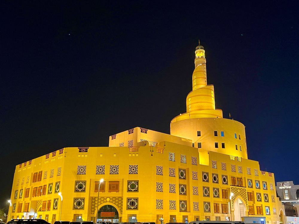 yellow light up building - One Day in Doha