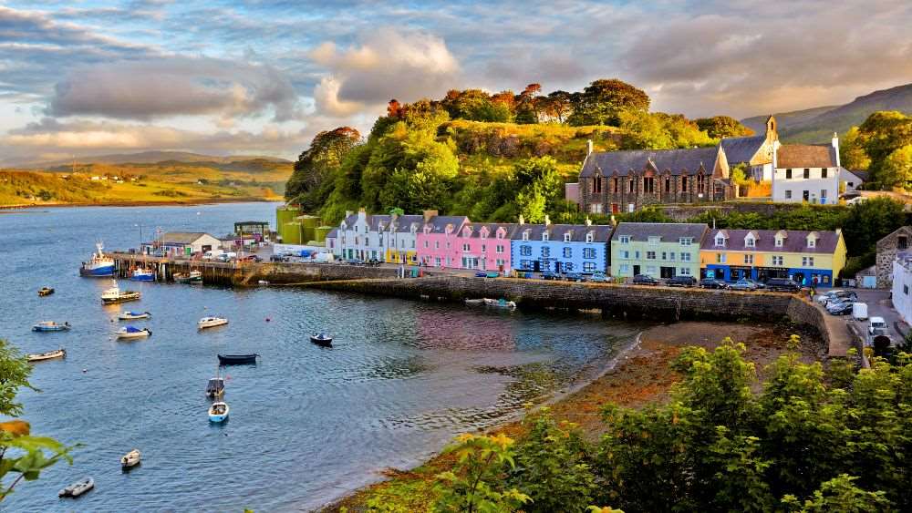 colorful houses near the mountain and body of water- Things to Do in Scotland